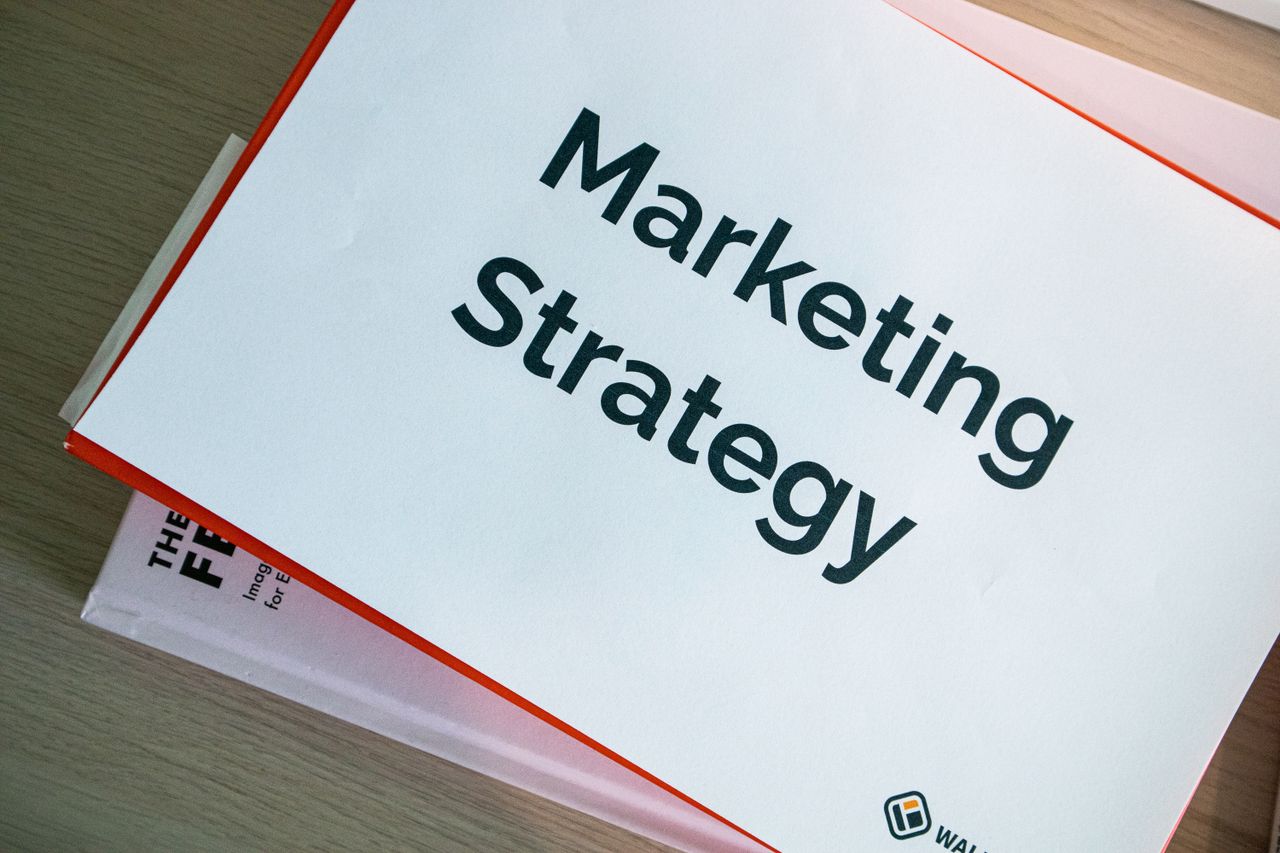 about-02 A marketing strategy document displayed on a desk, showcasing business planning essentials.